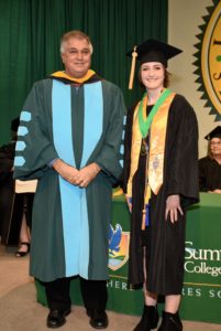Emily Sonnenberg receives her LSSC medallion on stage after being named the Fall 2018 President’s Award winner by Dr. Stan Sidor.